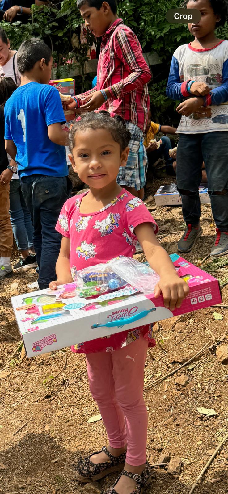 A child receiving a gift during a community outreach