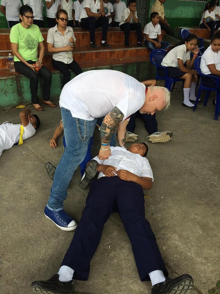 Pastor Michael Chamberlain praying with a student during an outreach