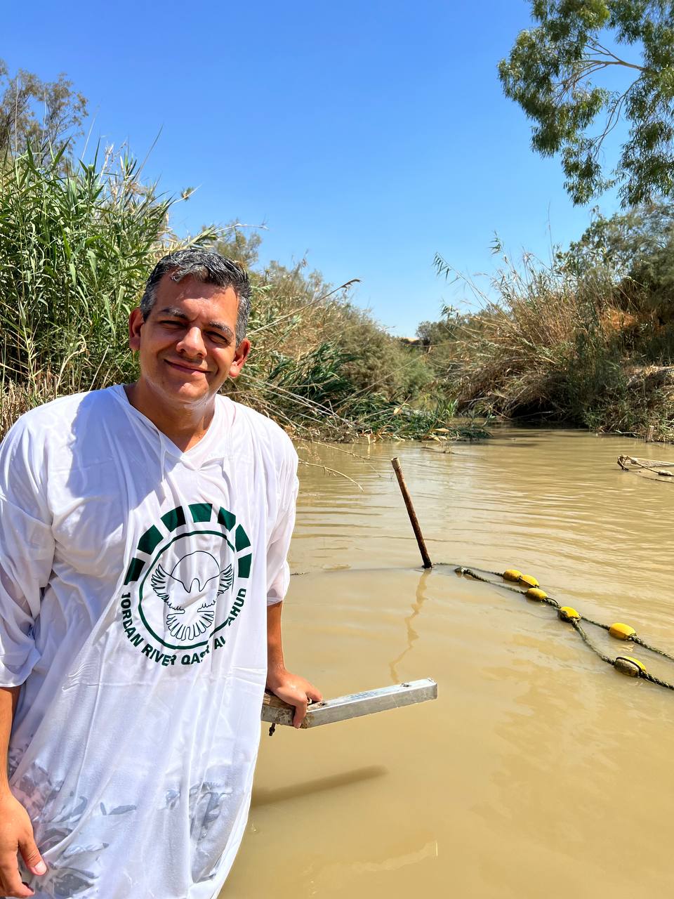 A person preparing for baptism at the Jordan River