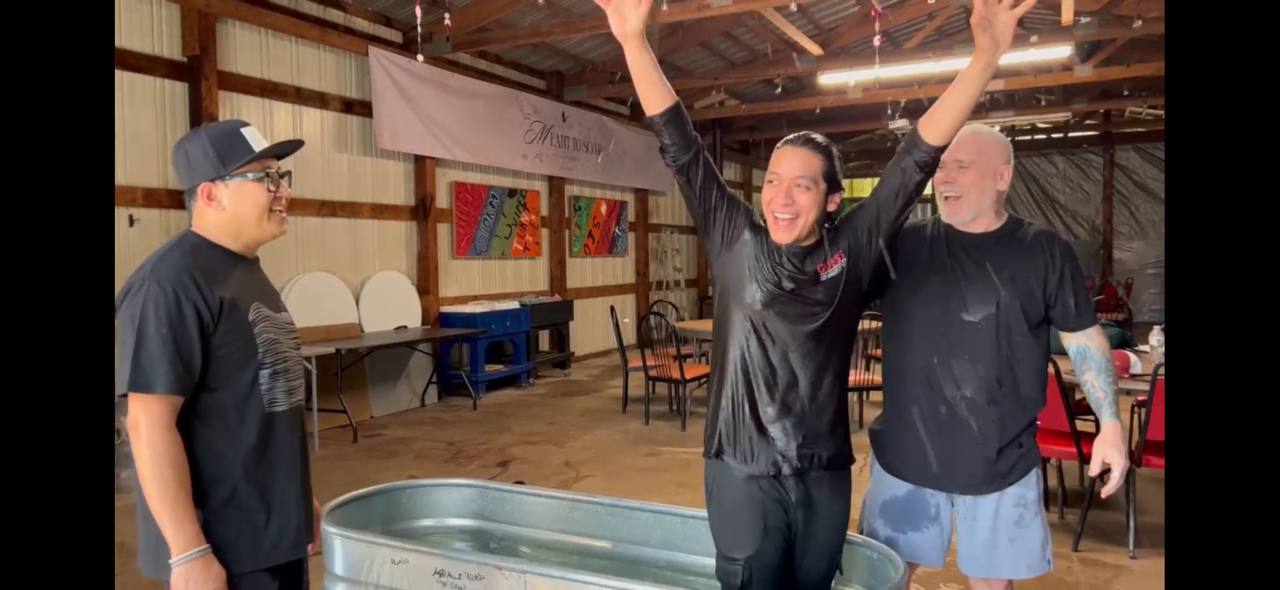 A joyful believer coming out of the water after baptism