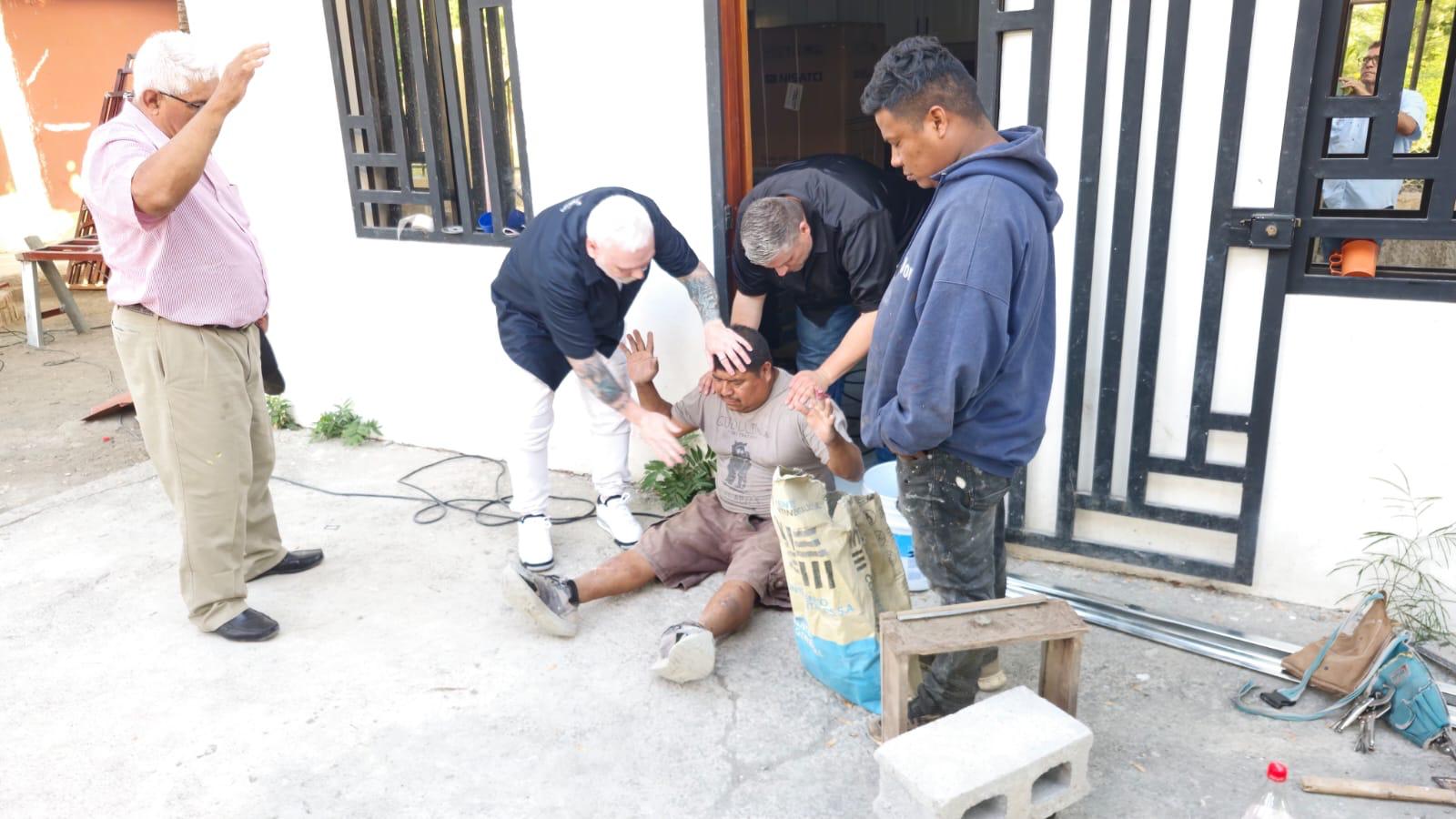Ministry leaders praying with someone during an outreach