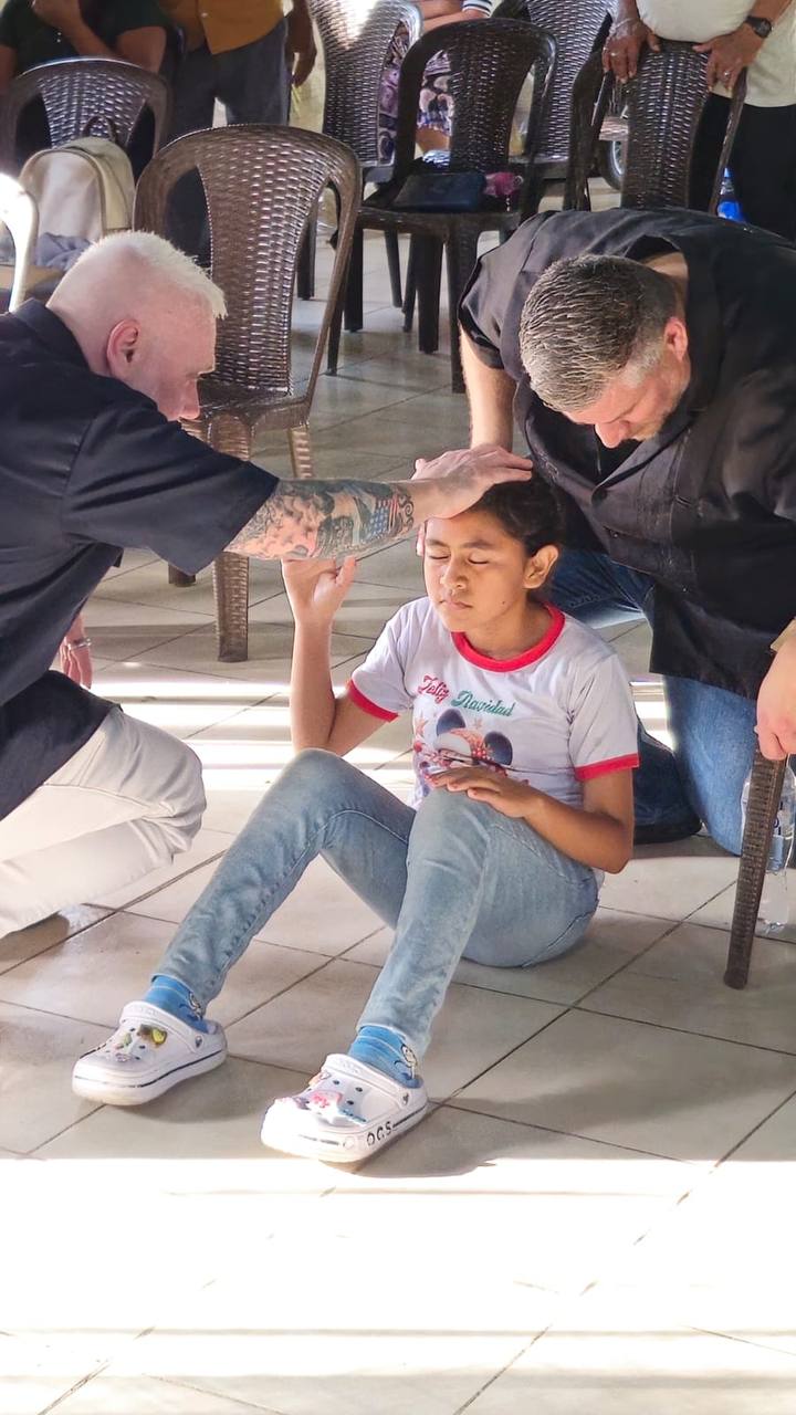 Ministry leaders praying for a young woman in Nicaragua
