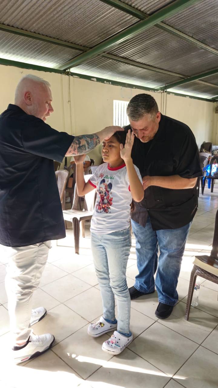 Ministry leaders praying for a young woman standing in Nicaragua