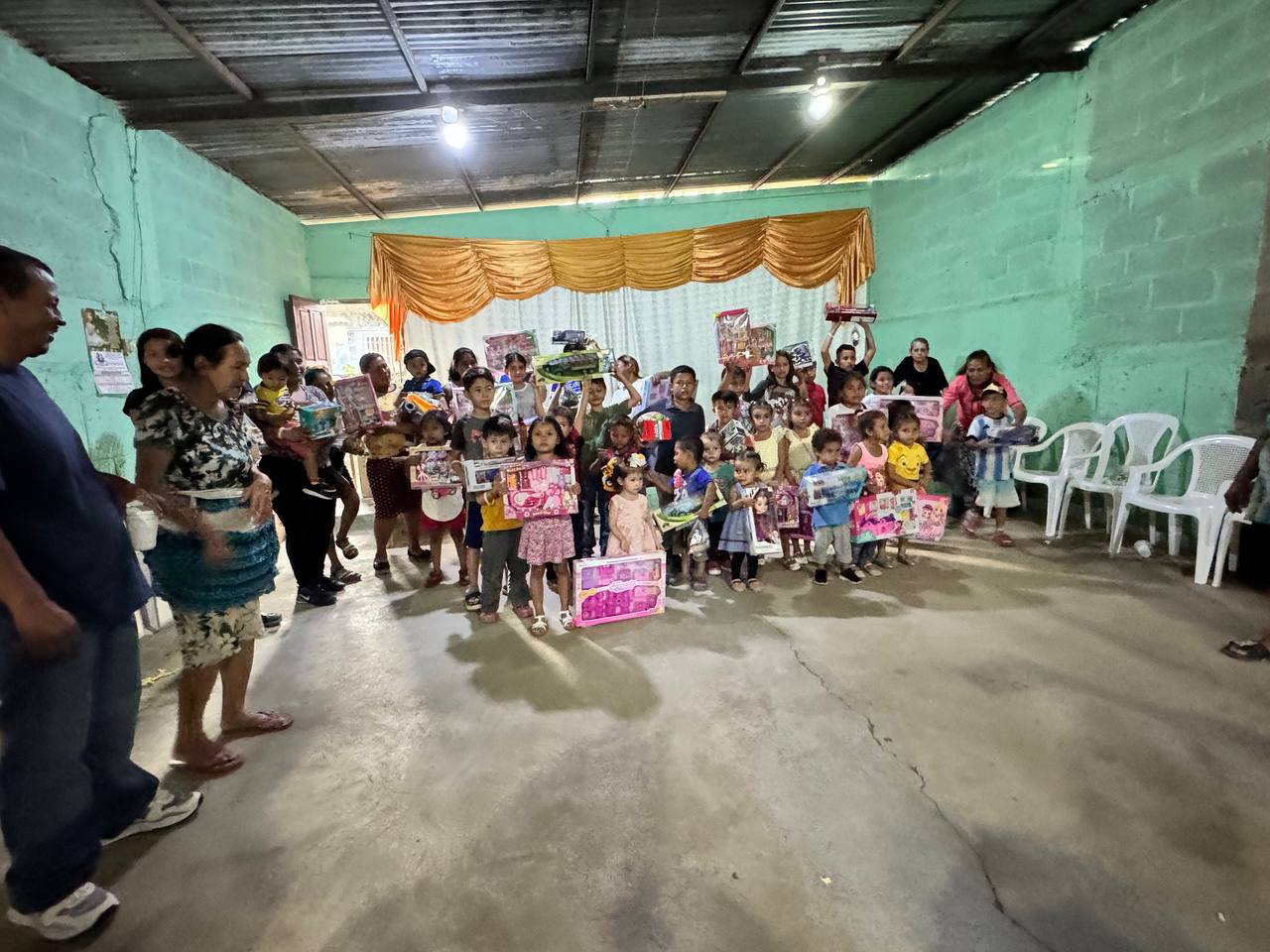 Children and families holding toys received during Rad Youth Outreach
